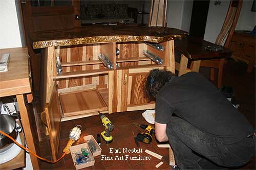 Earl installing custom made live edge cabinet